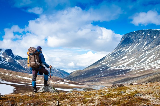 Tourist with a backpack and mountain panorama