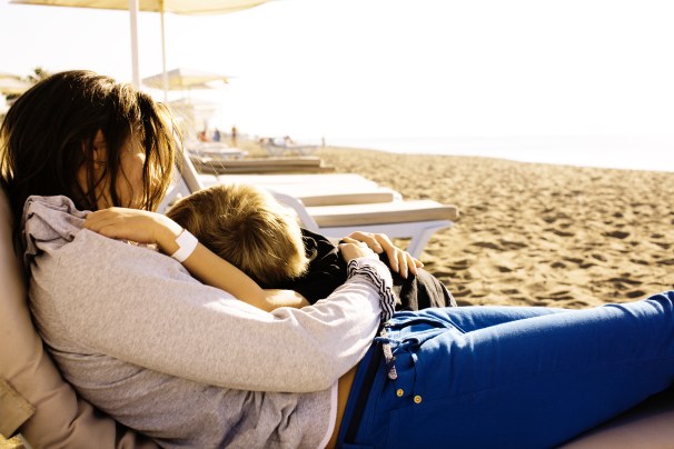 young mother with son resting on sea coast happy family together talking lifestyle people concept.jpg